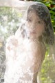 A woman in a wedding dress with a veil over her head.