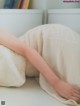 A person laying on a bed with a pillow.